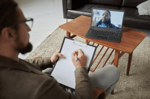 A behavioral health provider conducting a virtual telehealth session through an EHR-integrated platform, representing the benefits of telehealth EHR in improving mental health care.
